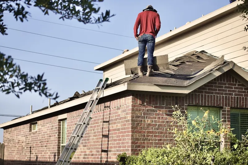 Professional roofer working on a residential roof in Frankfort